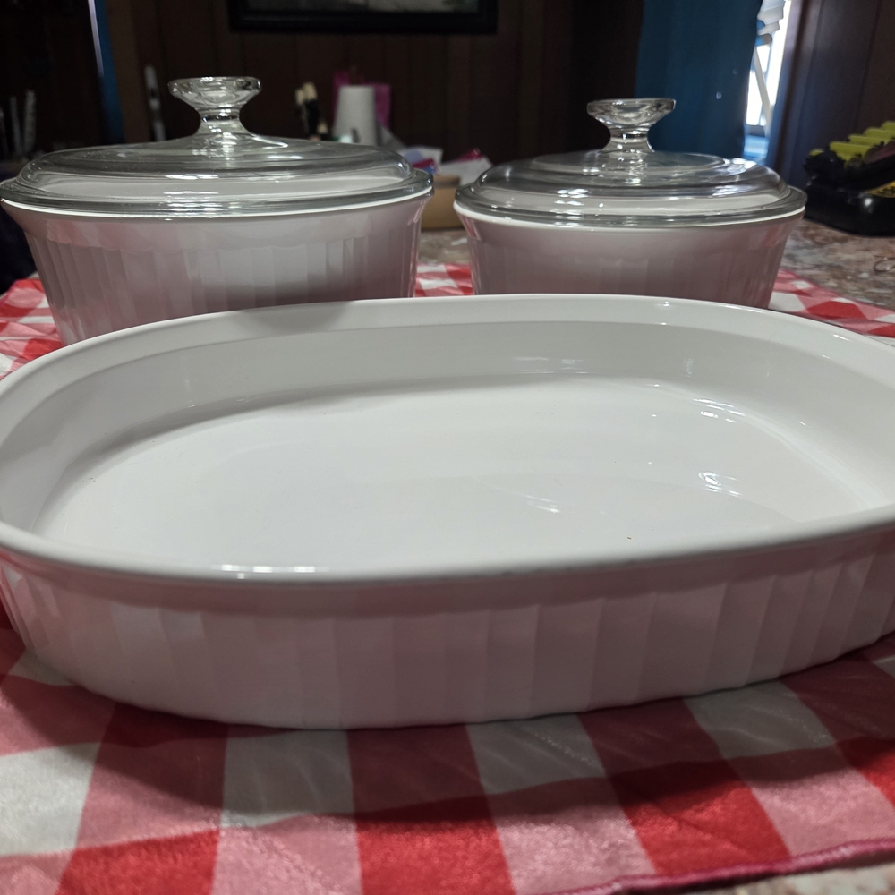 A 3-piece set of white CorningWare French White casserole dishes with glass lids